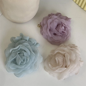 Three elegant mesh rose hair ties in dusty blue, purple, and apricot with pearl detail