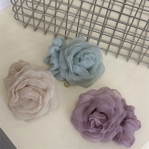 Three elegant mesh rose hair scrunchies with pearl S-pendants in beige, blue, and purple