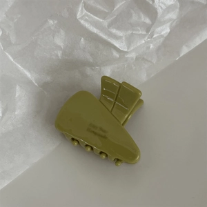 Close-up of olive green acetate triangular hair claw clip with Amy Bear lettering