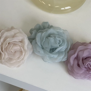 Detailed close-up of multi-layer mesh rose hair ties in soft Morandi pastel colors