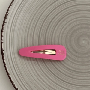 Detailed macro view of the matte pink hair clip with France Handmade engraving