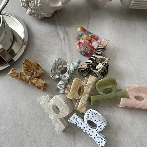 Close-up of premium acetate hair claws with marble and tortoiseshell patterns