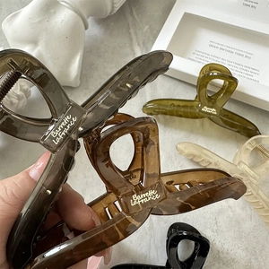 Large Korean style translucent claw clips set in various colors with elegant golden branding