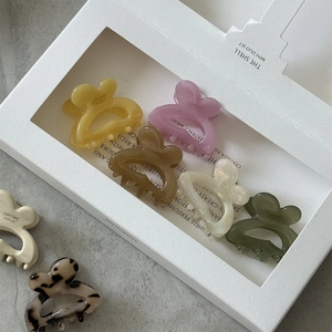 Detailed view of colorful mini butterfly hair claws in acetate and leopard print