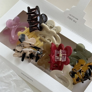 Detail showing colorful acetate rabbit hair clips in various patterns and colors