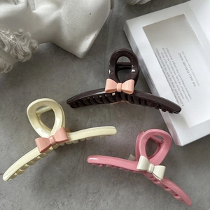 Three-piece resin bow hair claw clips set in brown, beige, and pink colors