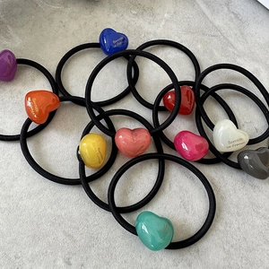 Close-up of colorful heart hair ties with elastic bands in multiple vibrant shades
