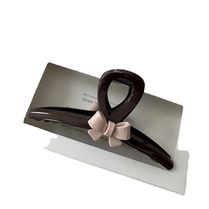 Brown resin claw clip with pink bow decoration for elegant women hair styling