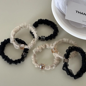 Detail of 6-piece chiffon hair scrunchies with square beads in black and beige