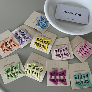 Set of colorful butterfly metal hair clips in pastel macaron shades on card boards