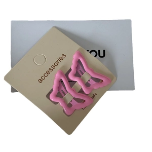 Pair of sweet pink butterfly hair clips for women on accessories display card