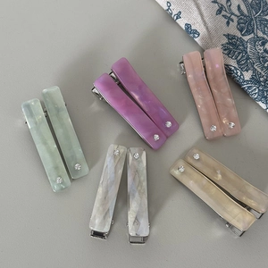 Set of ten colorful rectangular acetate hair clips with subtle rhinestone embellishments