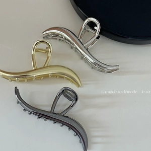 Three minimalist large metal hair claws in silver, gold, and charcoal grey finishes
