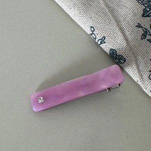 Detail of purple marble acetate hair clip with rhinestone and silver metal duckbill clip