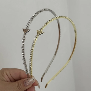 Sleek metal headband with inlaid rhinestones and Lucky engraved triangular logo