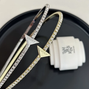 Close-up of gold and silver open bracelets with sparkling rhinestones and LUCKY engraving