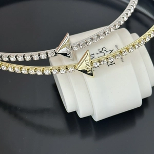 Detailed macro view of gold and silver rhinestone headbands featuring a Lucky triangle charm