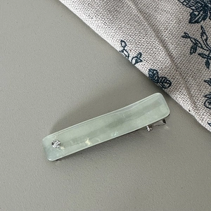 Detail of light green marble texture hair clip with rhinestone and metal duckbill clip
