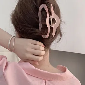 Pink translucent resin hair claw clip with large wavy design for long hair styling