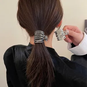 Minimalist liquid metal hair claw clip in glossy silver finish for high ponytail styling