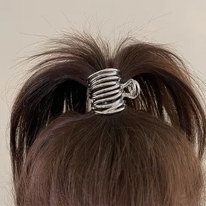 Detail view of the silver metallic spiral hair claw clip for high ponytail styling