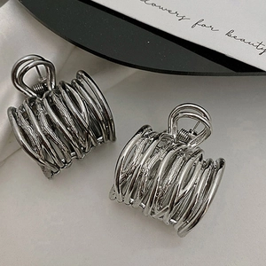 Detail of silver metal hair claws with elegant multi-layer wire winding minimalist design