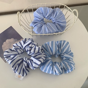 Three-piece set of minimalist blue and white striped fabric scrunchies for women