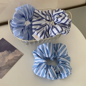 Three-piece set of blue striped hair scrunchies in a white metal basket, Korean style