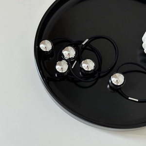 Detail of high-elastic black hair ties with large polished silver mirror beads