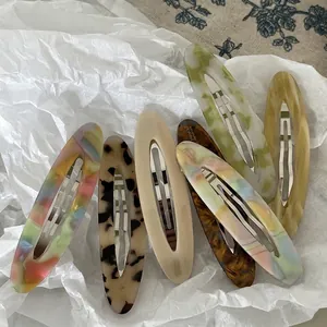 Set of seven acetate oval hollow hair clips in marble and tortoiseshell patterns