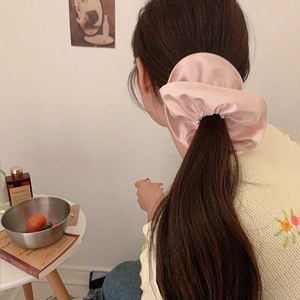 Pink satin oversized scrunchie with delicate pearls for elegant ponytail styling