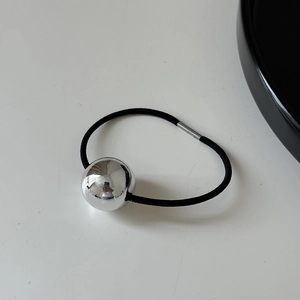 Detail of high-elastic black hair tie featuring a large polished silver metal bead