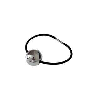 Minimalist elastic hair tie with large polished silver metal ball on white background