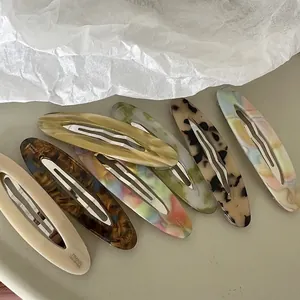 7-piece set of handmade acetate geometric oval hair clips in assorted marble and tortoise patterns