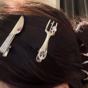 Silver cutlery hair clips with rhinestones shown on hair for a creative metallic look