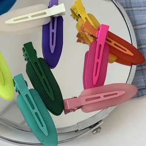 Matte jelly color hair clip set on mirror background with colorful matte duckbill clips