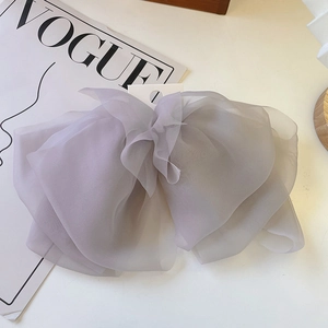 Detail of lavender layered organza bow hair clip showing translucent fabric texture