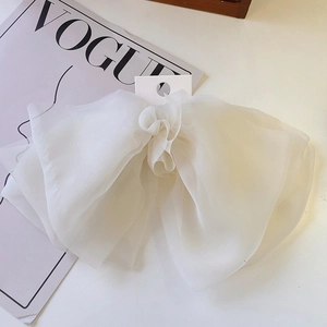 Detail of multi-layered white chiffon butterfly hair clip with sheer wave texture
