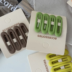 Close-up of four-piece matte BB hair clip sets in cream coffee, green, and yellow colors