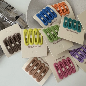 8-piece set of matte cream-colored oval BB hair clips for women in assorted vibrant colors
