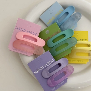 Détail de pinces à cheveux couleur macaron avec finitions polies et mates