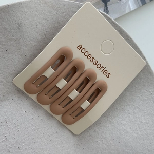 Detail of 4-piece matte khaki BB hair clips set on accessory display card