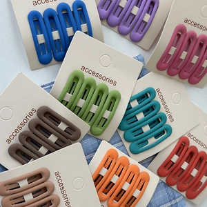 Detailed view of matte oval BB hair clips in various cream colors on display cards