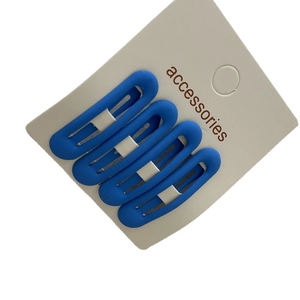 Set of four matte blue oval hollow hair clips on a white accessories display card