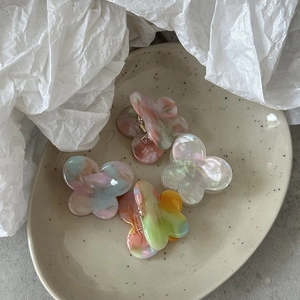 Elegant acetate hair clips in butterfly and flower shapes with pastel marble textures