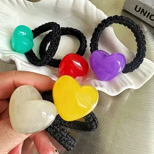 Set of five colorful jelly heart elastic hair ties with thick braided black cords on a tray