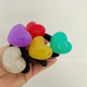 Detail of five colorful jelly heart hair ties with durable thick black elastic bands