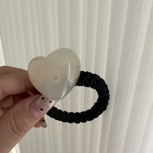 Detailed close-up of handmade jelly heart charm on thick black elastic hair tie