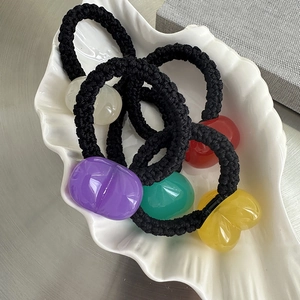 Colorful jelly resin heart hair ties set on a white shell tray with braided ropes