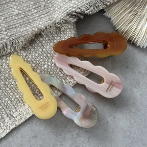 Set of four wave-edged acetate hair clips in marble and pearlescent colors